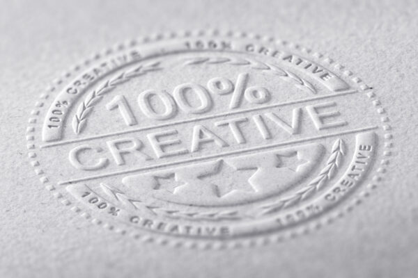 3D illustration of a stamp embossed on a paper texture with the text one hundred percent creative, horizontal image. Communication concept for creative advertising company